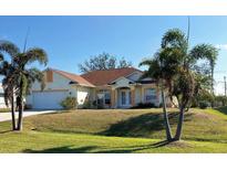 Inviting single-story home with manicured lawn and lush palm trees at 9350 Gulfstream, Englewood, FL 34224