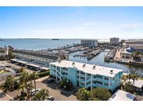 Beautiful aerial view of the condo community with boat slips and waterfront views on a clear day at 423 S Paula Dr # 304, Dunedin, FL 34698