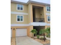 Charming two-story condo with a one-car garage, quaint landscaping, and covered balcony at 6421 Banyan Blvd # 302, New Port Richey, FL 34652