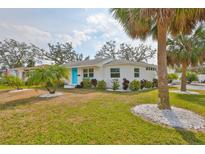 Charming single-story home with well-maintained lawn, landscaping, and a bright blue front door at 6560 5Th S Ave, St Petersburg, FL 33707