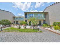 Charming condo with a well-maintained brick drive and lush landscaping at 1028 Apollo Beach Blvd # 13, Apollo Beach, FL 33572