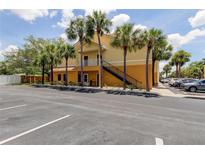 Two story condo building with parking and multiple palm trees at 10764 70Th Ave # 2110, Seminole, FL 33772