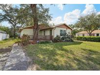 Charming single-story home featuring a well-maintained lawn and inviting front porch at 1801 E Mcberry St, Tampa, FL 33610