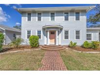 Charming two-story home with a landscaped yard and inviting brick walkway leading to the front door at 535 28Th N Ave, St Petersburg, FL 33704