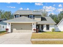 Charming two-story home featuring a well-maintained lawn and neutral two-car garage at 8814 Hampden Dr, Tampa, FL 33626