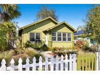 Charming bungalow with green paint, white picket fence and manicured lawn at 123 17Th Se Ave, St Petersburg, FL 33701