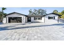 Beautifully renovated single story home with a paver driveway and manicured landscaping at 1514 Sea Gull S Dr, St Petersburg, FL 33707