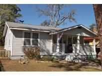 Charming single-story home with a cozy front porch and well-maintained landscaping at 1736 14Th N St, St Petersburg, FL 33704