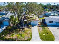 Charming single-story home featuring a well-manicured front yard and an attached single-car garage at 1826 Nevada Ne Ave, St Petersburg, FL 33703