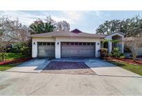 A two car garage with doors and concrete driveway at 3037 Crest Dr, Clearwater, FL 33759