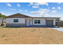 Charming single-story home with neutral paint, brick accents, and well-lit front entrance at 3246 Thorny Ridge Dr, Holiday, FL 34691