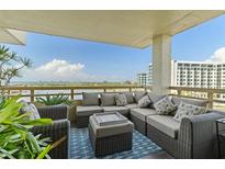 Spacious balcony featuring comfortable seating, plants, and scenic waterfront views on a sunny day at 5701 Mariner St # 606, Tampa, FL 33609