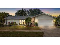 Charming single-story home with a well-manicured lawn and beautiful landscaping at 10222 95Th St, Seminole, FL 33777