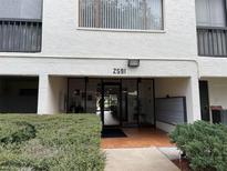 Exterior view of building entrance with glass doors and unit number above the door at 2591 Countryside Blvd # 5203, Clearwater, FL 33761