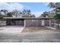 Charming brick home featuring a fenced yard and a covered parking area at 3817 N 54Th St, Tampa, FL 33619