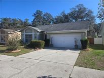 Charming single-story home featuring a well-maintained lawn and a two-car garage at 4010 Levonshire Pl, Valrico, FL 33596