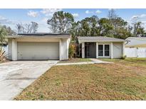 Charming single-story home with a two-car garage and well-maintained front yard at 4504 Grainary Ave, Tampa, FL 33624