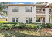 Inviting condo featuring lush landscaping, stucco walls, and ample natural light from the many windows at 7802 Hardwick Dr # 1117, New Port Richey, FL 34653