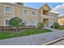 Inviting condo exterior with well-maintained landscaping and neutral color palette at 6017 Portsdale Pl # 101, Riverview, FL 33578