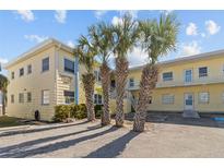 Bright, two-story condo building with palm trees and ample parking at 9895 1St E St # 5, Treasure Island, FL 33706