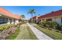 Attractive community featuring sidewalks, mature landscaping, and terra cotta roofs at 19029 Us Highway 19 N # 19C, Clearwater, FL 33764