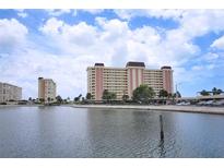 Scenic waterfront condo building boasting beautiful architecture, lovely landscaping, and ample parking at 4775 Cove Cir # 205, St Petersburg, FL 33708