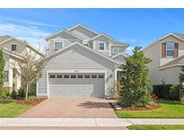 Charming two-story home featuring a brick driveway, a two-car garage, and well-maintained landscaping at 6219 Voyagers Pl, Apollo Beach, FL 33572