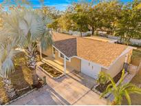 Aerial view of a well-maintained property with lush landscaping and a private driveway at 7507 Betula Dr, New Port Richey, FL 34653