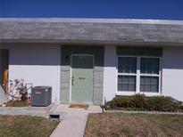 Inviting home featuring a decorative front door, window, and lush, green landscaping at 7729 39Th N Ter, St Petersburg, FL 33709