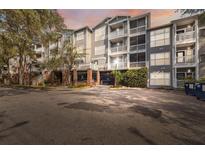 Charming multi-story condominium building featuring private balconies and secure gated access at 800 S Dakota Ave # 323, Tampa, FL 33606