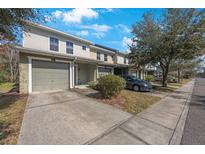 Townhome exterior showing attached garage, and manicured lawn at 8004 Downpatrick Ct, Tampa, FL 33610