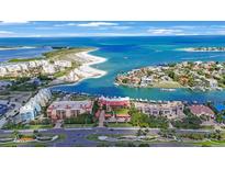 Stunning aerial view of waterfront property, showcasing the community and the beautiful turquoise ocean and nearby beaches at 1060 Pinellas Bayway S # 103, St Petersburg, FL 33715