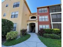 Inviting condominium building exterior with manicured landscaping and walkway to the units' entrance at 11901 4Th N St # 10102, St Petersburg, FL 33716