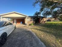 Modest single story home with a covered carport and a simple brick facade at 1302 Highview Rd, Brandon, FL 33510