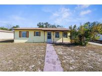 Charming single-story home with a welcoming front porch and a well-maintained lawn at 6353 Spring Hill Dr, Spring Hill, FL 34606