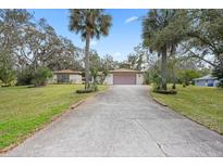 Charming single-story home featuring a spacious front yard and a long private driveway at 6524 Coronet Dr, New Port Richey, FL 34655