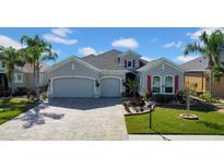 Charming single-Gathering home with a three-car garage, manicured lawn, and beautiful landscaping at 1545 Emerald Dunes Dr, Sun City Center, FL 33573