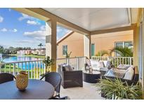 Relaxing outdoor patio with comfortable seating overlooking a scenic lake and water fountain at 18 Franklin S Ct # D, St Petersburg, FL 33711