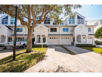 Charming townhomes with crisp white facade, attached garages, and well-manicured lawns in a neighborhood setting at 14700 Seminole Trl, Seminole, FL 33776