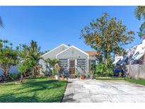 Charming single-story home with a well-manicured lawn, inviting front entrance, and a concrete driveway at 2885 18Th N Ave, St Petersburg, FL 33713