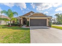 Charming single-story home with well-maintained lawn, mature trees, and a spacious two-car garage at 38205 Countryside Pl, Dade City, FL 33525