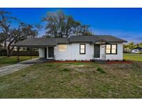 Charming single-story home with a covered carport and a well-maintained front lawn at 38638 2Nd Ave, Zephyrhills, FL 33542