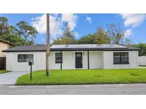 Charming single-story home with a well-maintained lawn and dark trim accents at 6291 63Rd N St, Pinellas Park, FL 33781