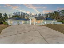 Spacious ranch-style house boasting a large driveway, solar panels, and a charming front entrance at 9911 Mendel Dr, New Port Richey, FL 34654