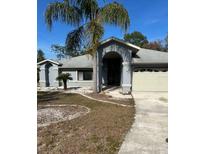 Charming single-story home with a two-car garage and well-maintained landscaping in a quiet neighborhood at 10075 Huckleberry Dr, Spring Hill, FL 34608