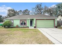 Charming single-story home featuring a well-maintained lawn and a two-car garage at 2259 Renton Ln, Spring Hill, FL 34609