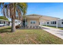 Charming single-story home with carport and mature palm tree in a sunny, well-maintained community at 5238 Vera St, Zephyrhills, FL 33542