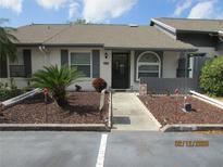 Charming home exterior with well-maintained landscaping and inviting entrance at 586 Rodeo Dr, Largo, FL 33771
