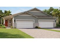 New home exterior with gray siding, a two-car garage, and well-manicured lawn at 6224 Timberdale Ave, Wesley Chapel, FL 33545