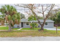 Charming gray home with a well-maintained lawn and mature trees at 800 51St S St, Gulfport, FL 33707